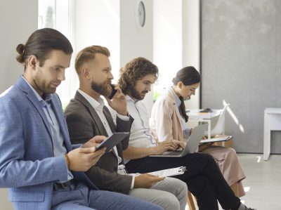 Group Of Young People Waiting In Line For A Job Interview Or Business Appointment