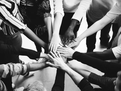 Diversity teamwork with joined hands