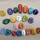 a-better-world-is-possible-social-issue-slogan-with-handmade-multi-colored-stone-letters-over-white_t20_rRQyEz