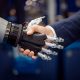 Hand of a businessman shaking hands with a Android robot.